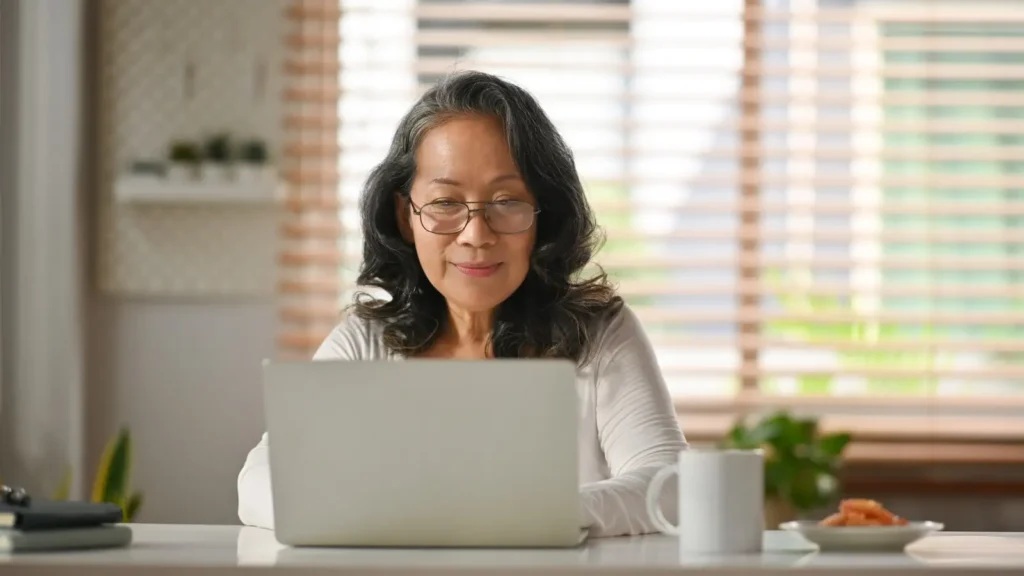 Woman researching term life insurance with her laptop while sitting at home
