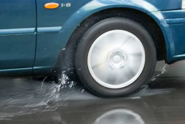 Automobile tires spinning while driving through rain